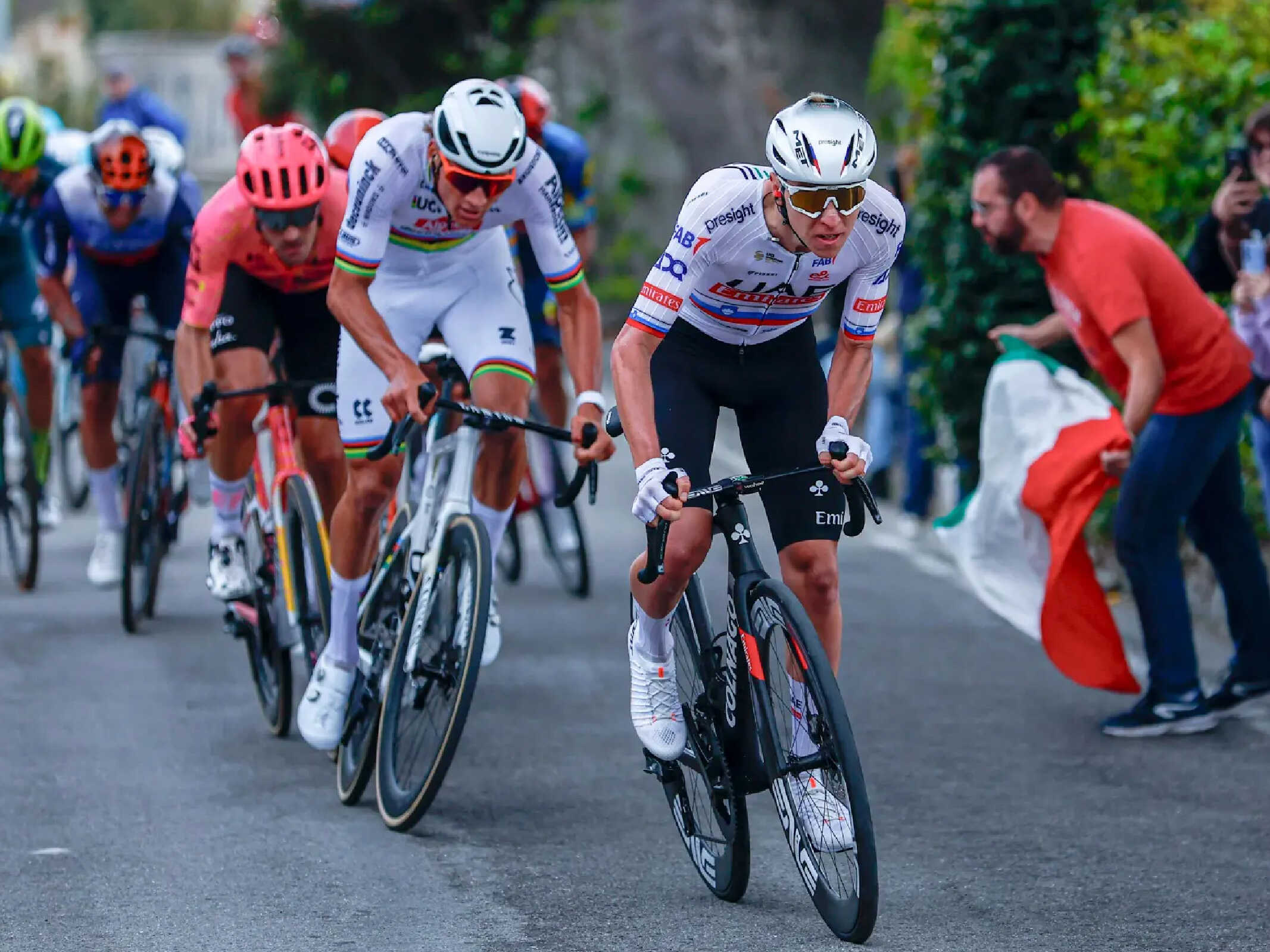 A road cyclist racing in the world champion’s Rainbow Jersey